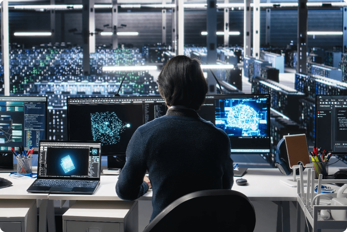 person sitting in front of multiple monitors