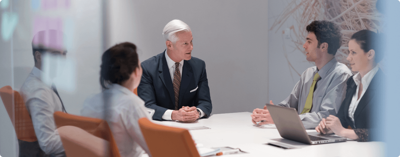 Executive team reviewing AI-powered business outcomes in a meeting room