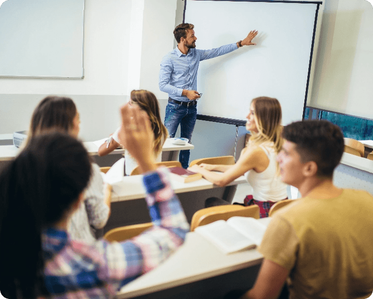 classroom with adolescents attending a class, teacher pointing at whiteboard